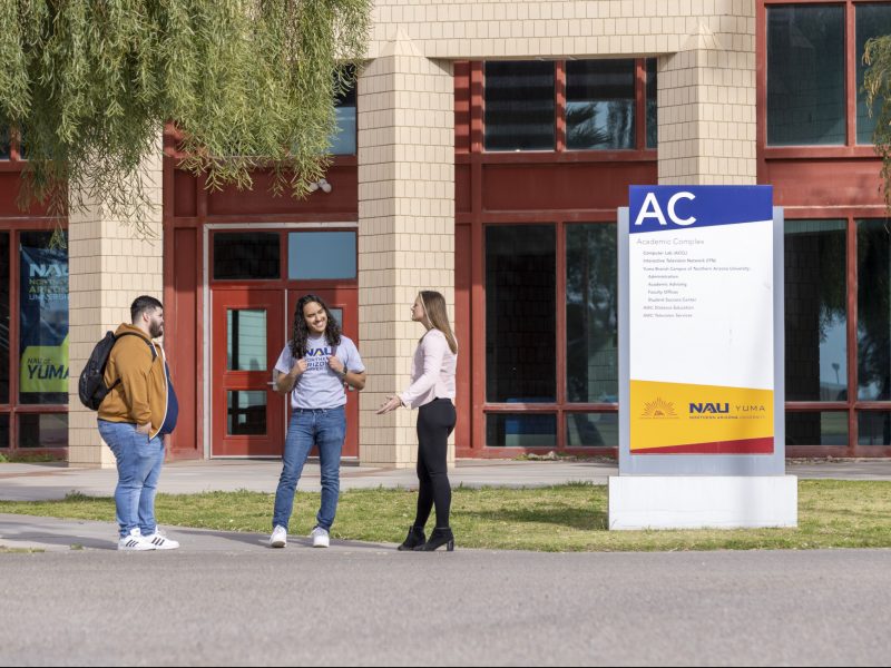 Students talking outside on N A U–Yuma campus.