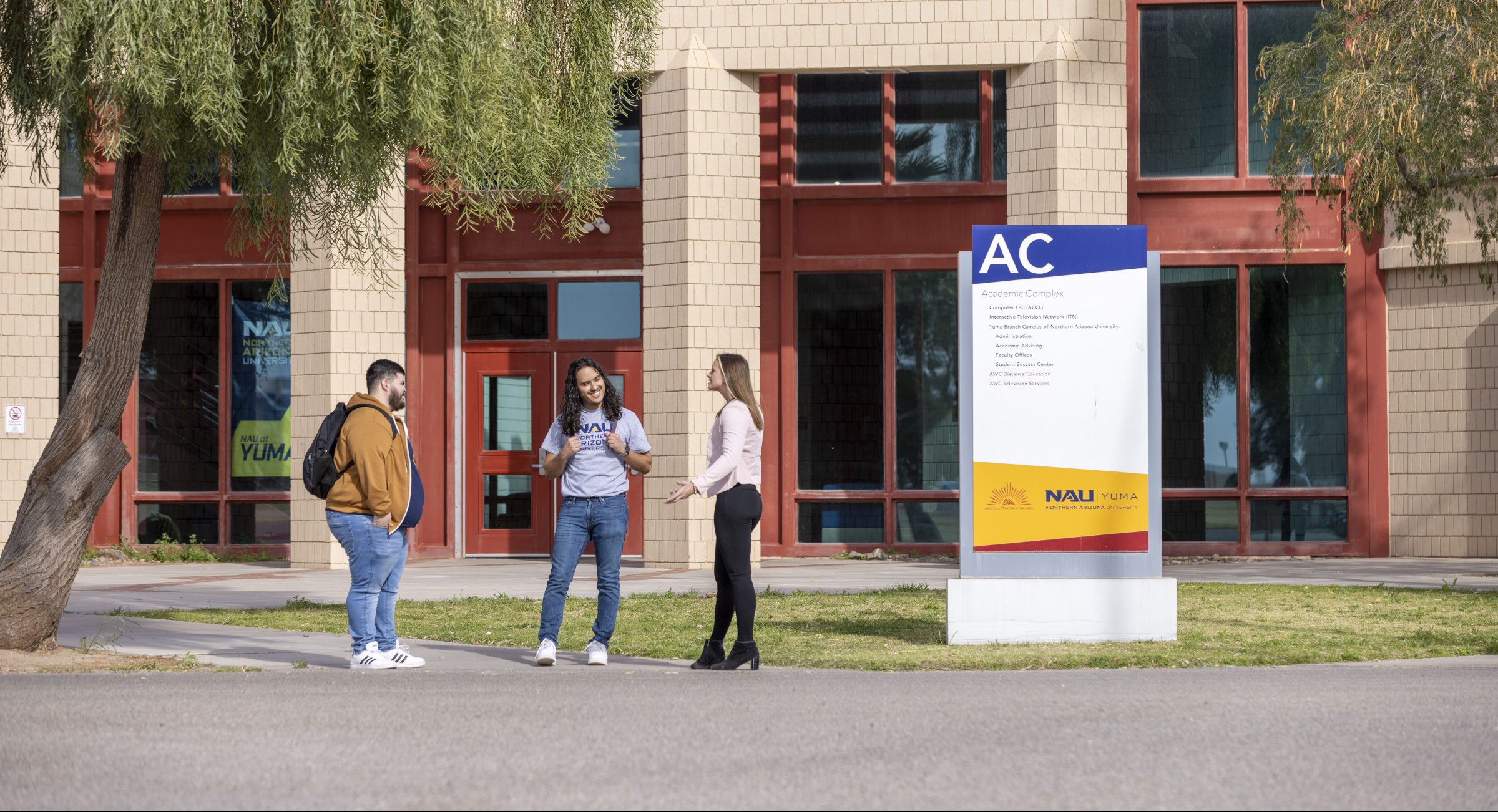 Students talking outside on N A U–Yuma campus.