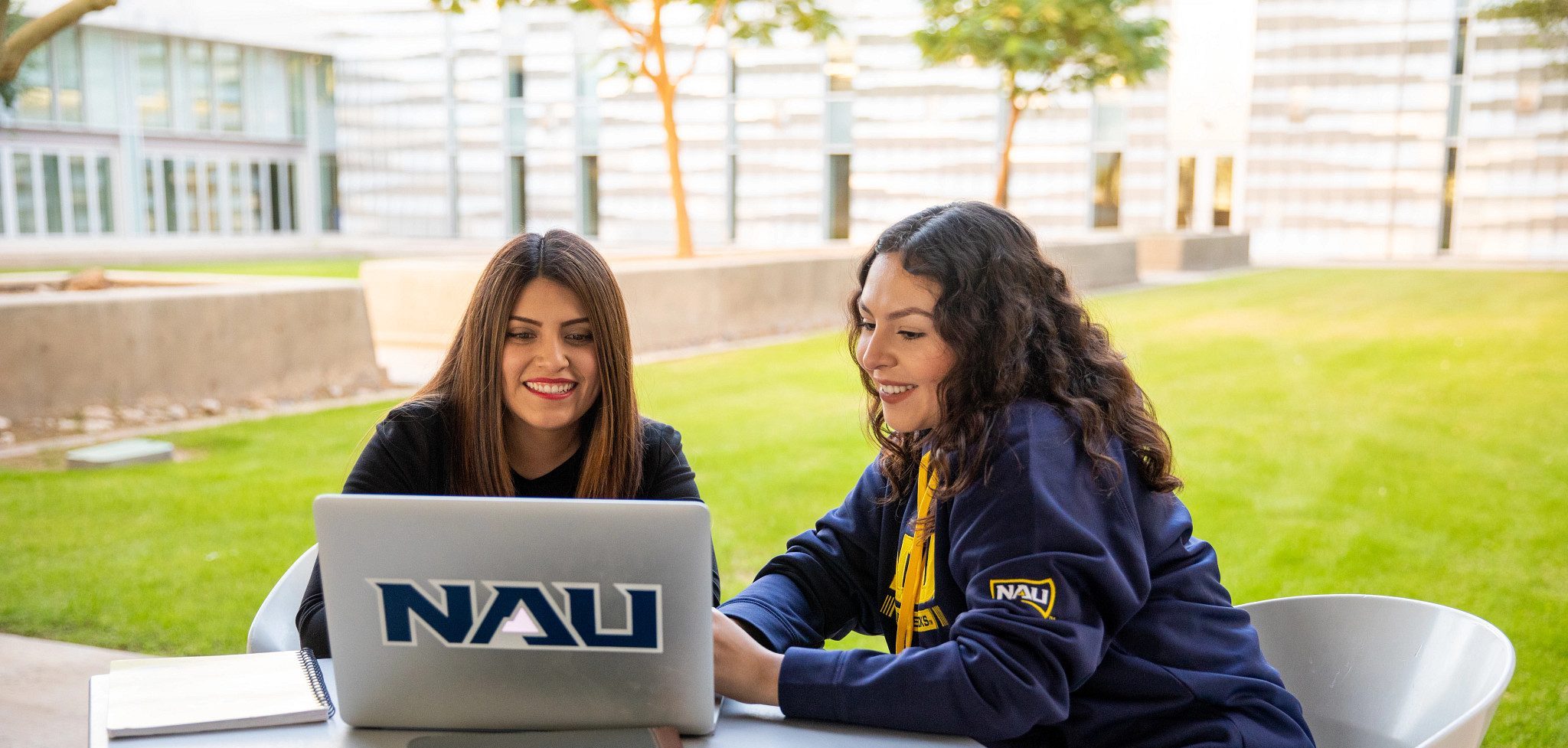 N A U&ndash;Yuma students outside working on Laptop.
