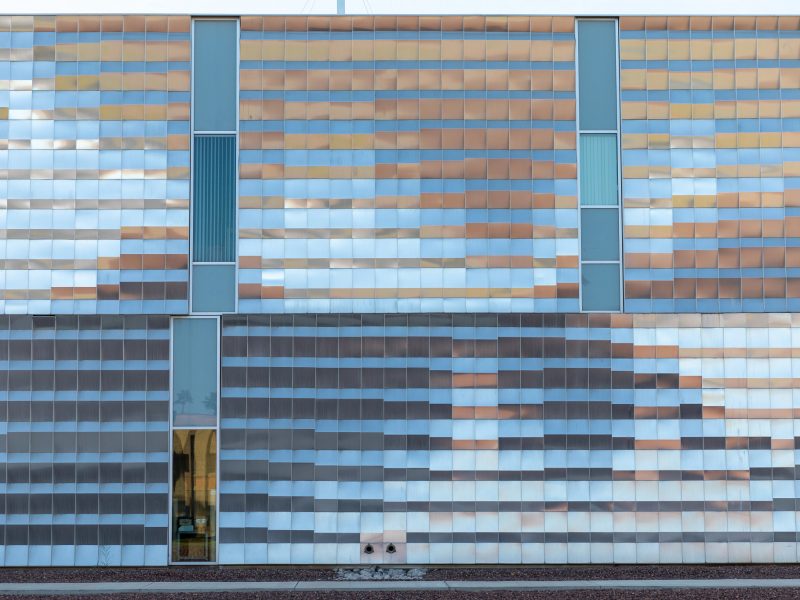Yuma campus building with large metallic sheets reflecting in the sun.