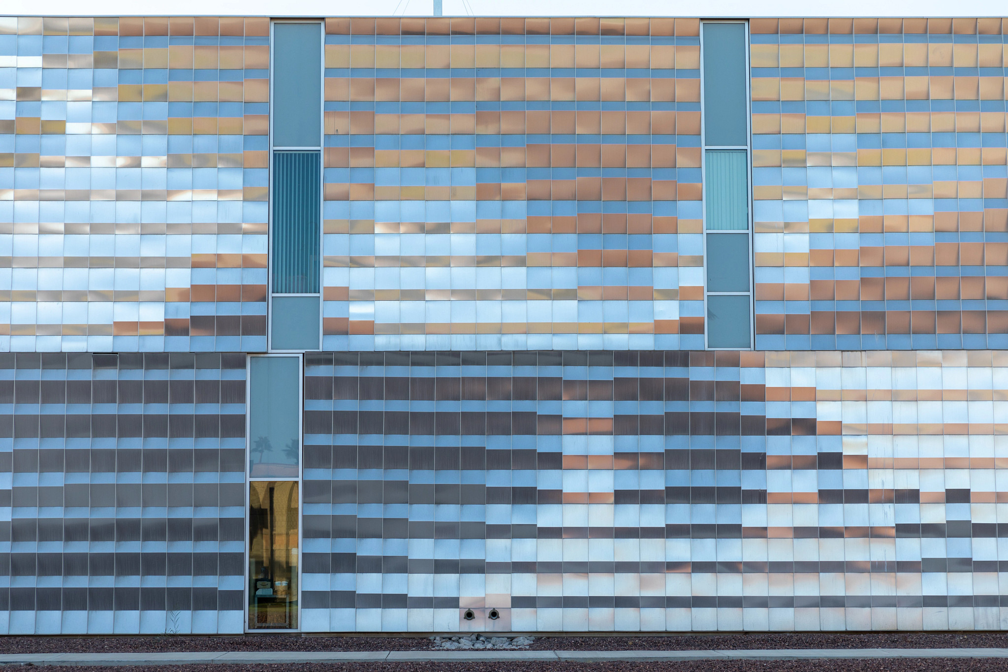 Yuma campus building with large metallic sheets reflecting in the sun.