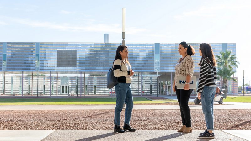 N A U-Yuma students talking with faculty on campus.