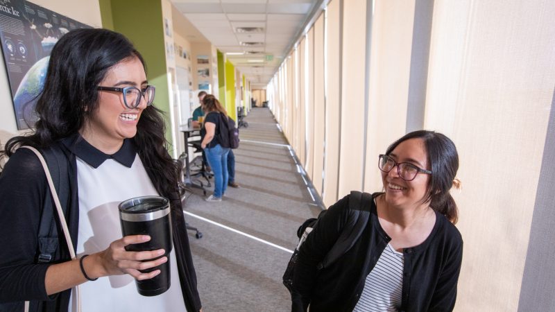 Two students sitting outside at N A U&ndash;Yuma campus.
