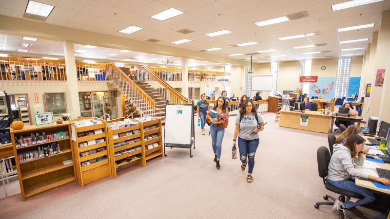 N A U students walking through the Yuma Campus library.