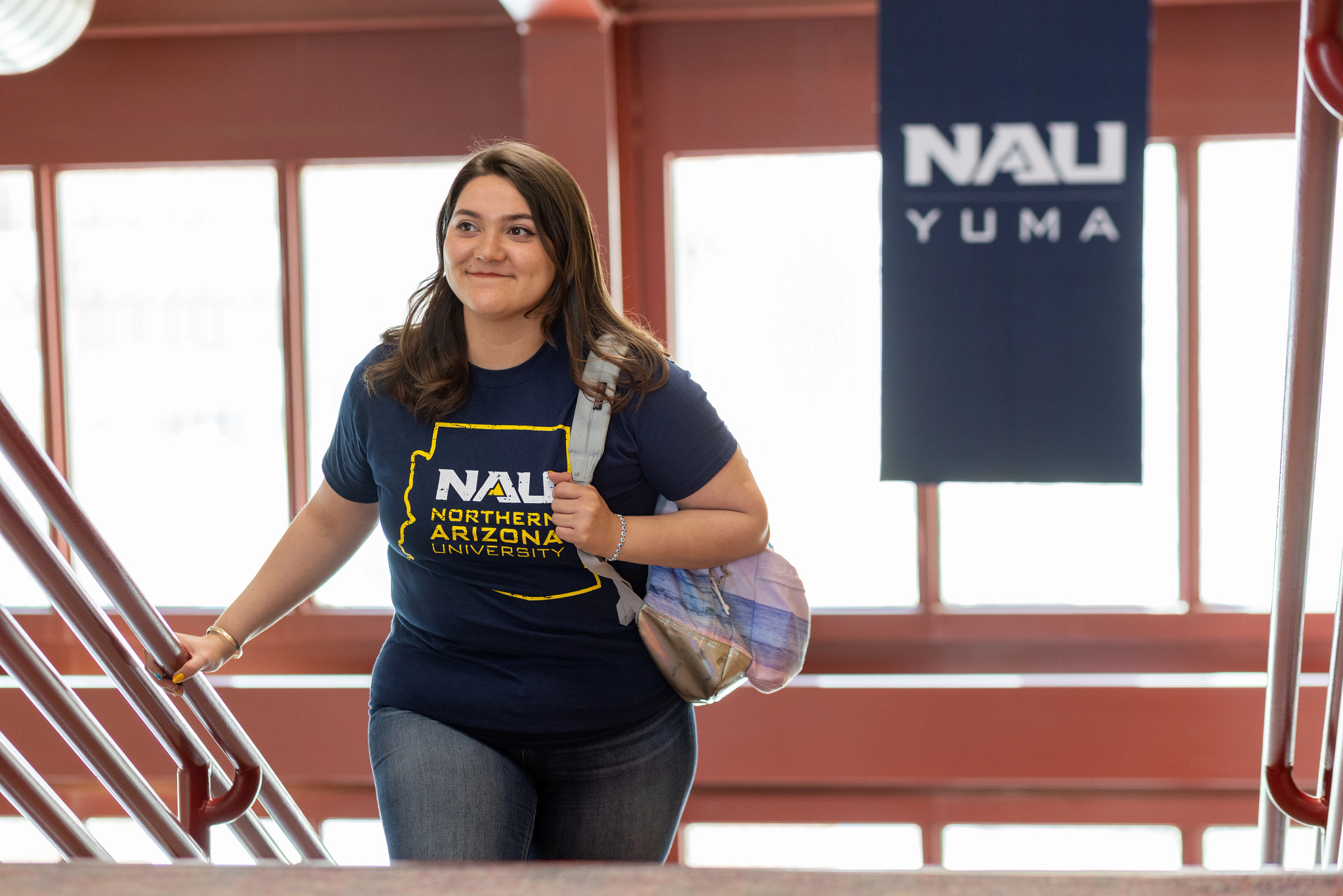 N A U&ndash;Yuma student walking up staircase.