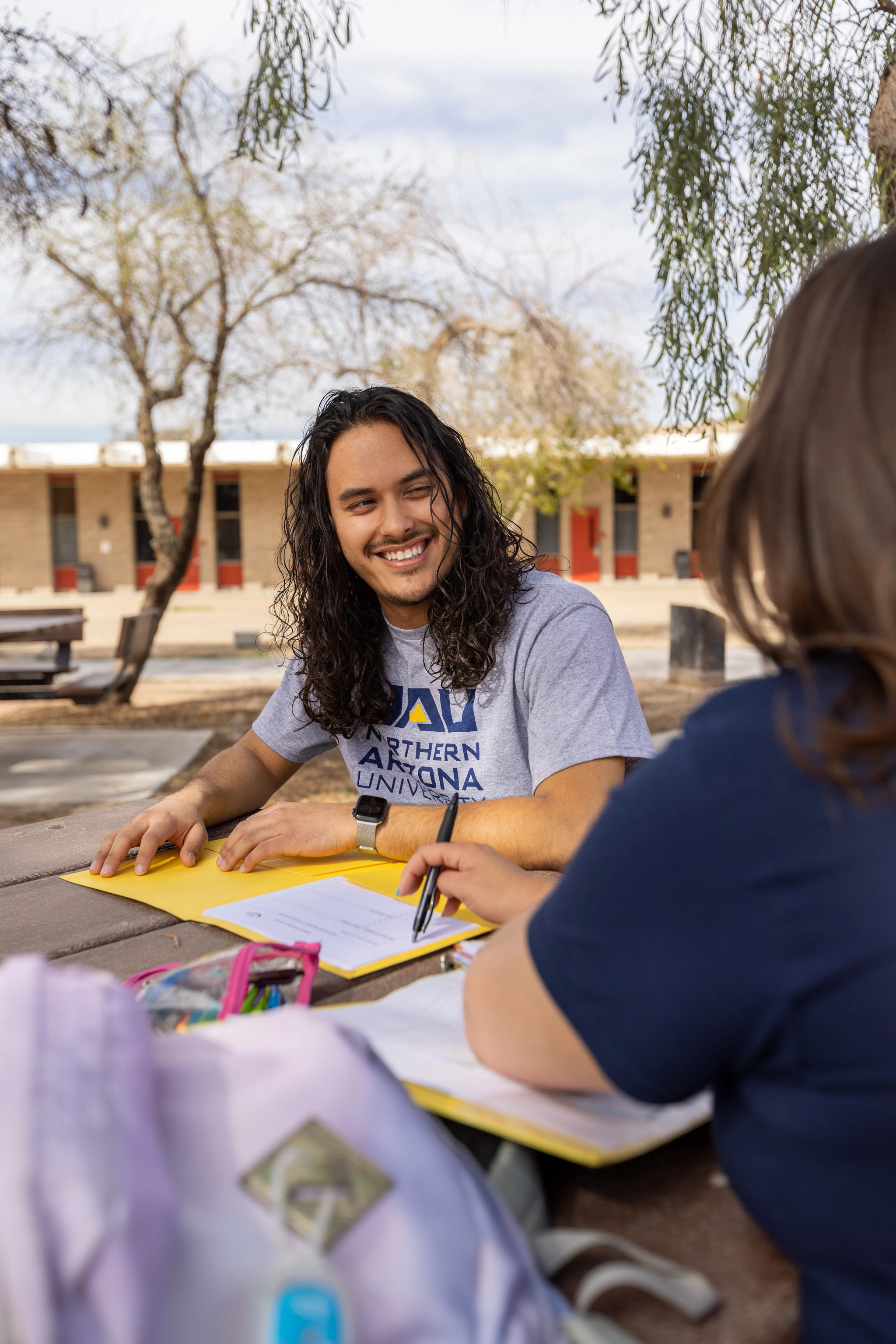N A U&ndash;Yuma students sitting outside.