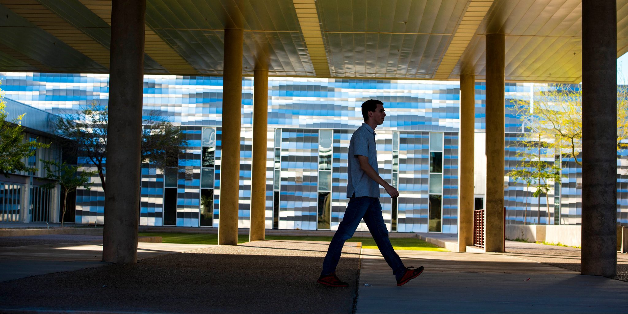 Person walking on N A U–Yuma campus.