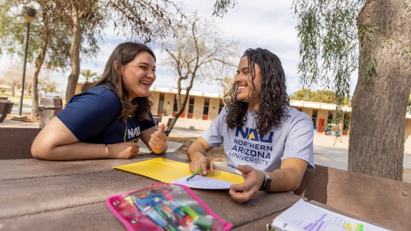 N A U&ndash;Yuma students working together outside.