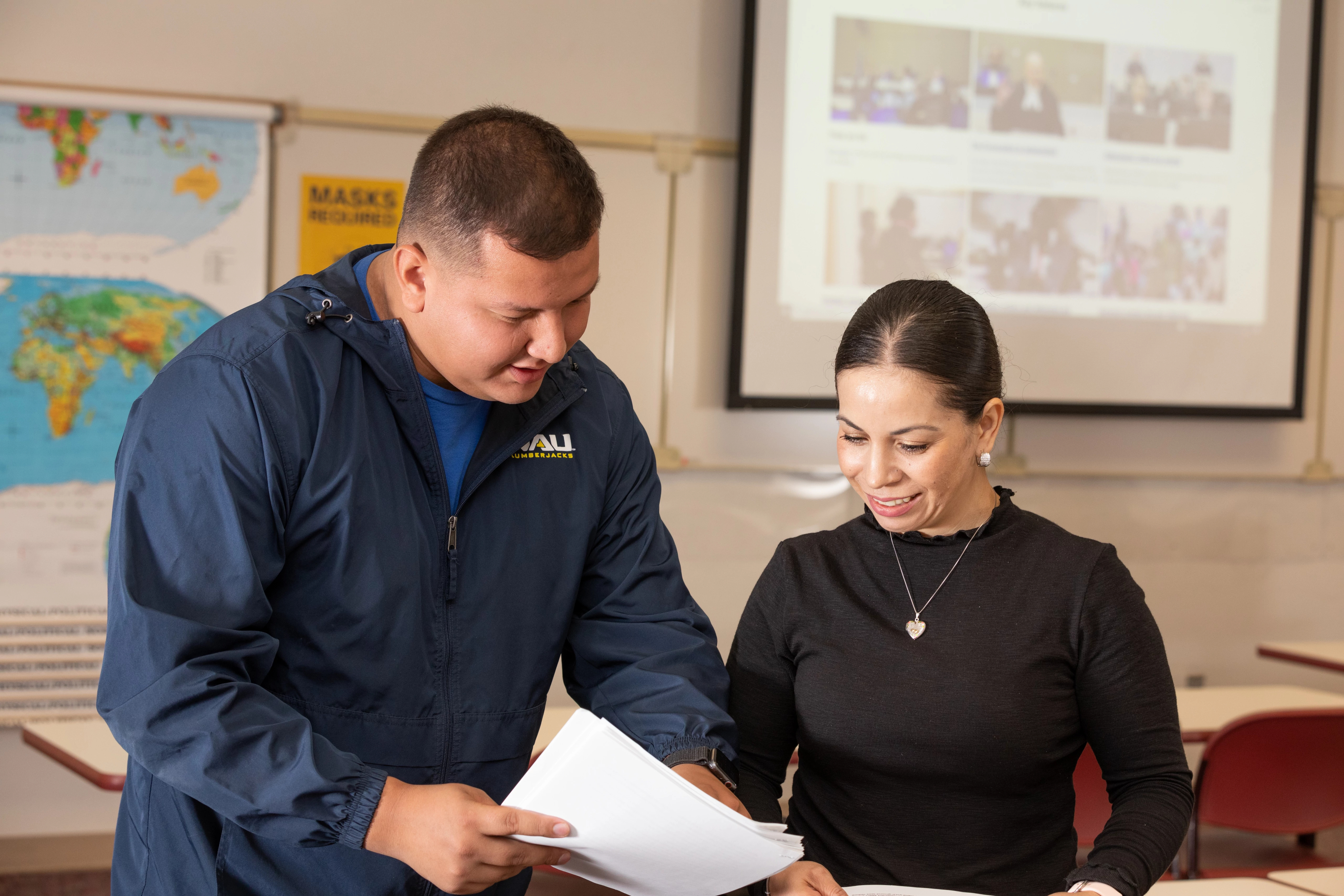 N A U&ndash;Yuma students consulting each other in class.