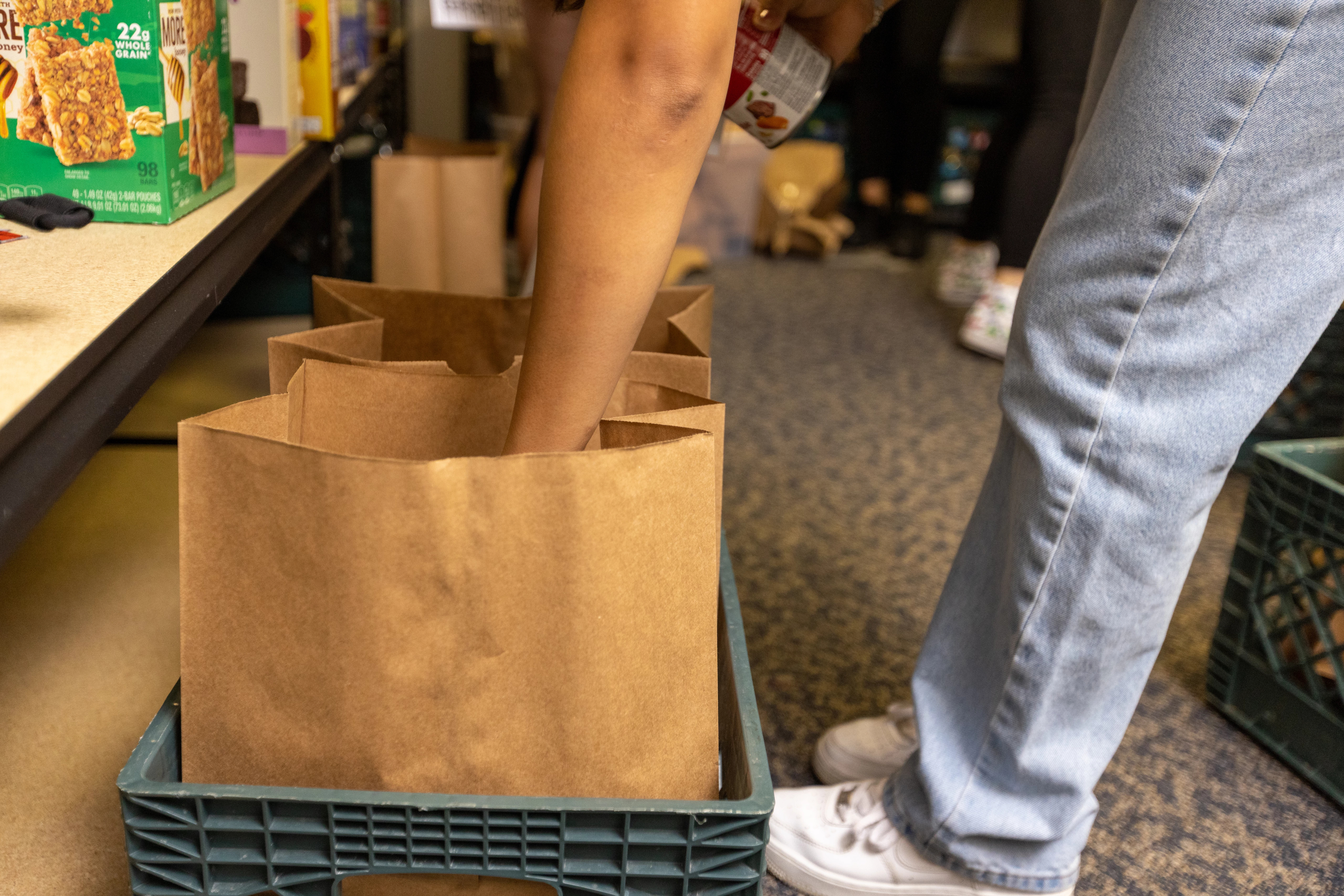 Students filling Louie's Cupboard bags to pass out.