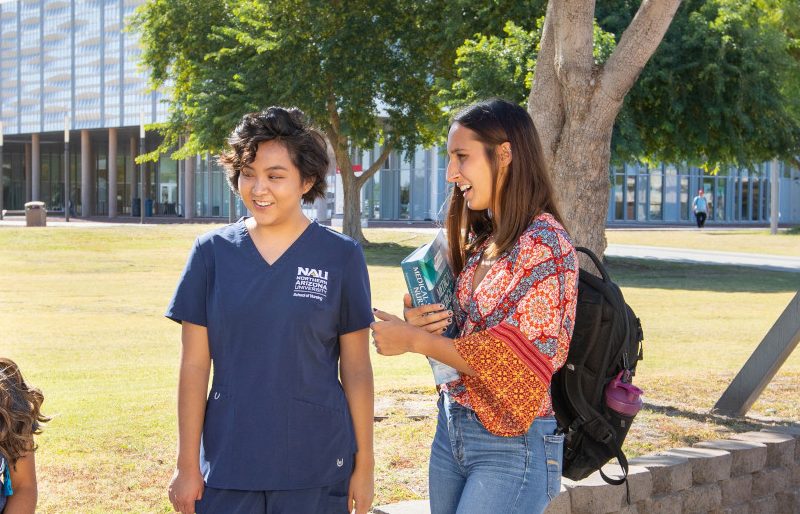 Students sitting outside on N A U&ndash;Yuma campus.