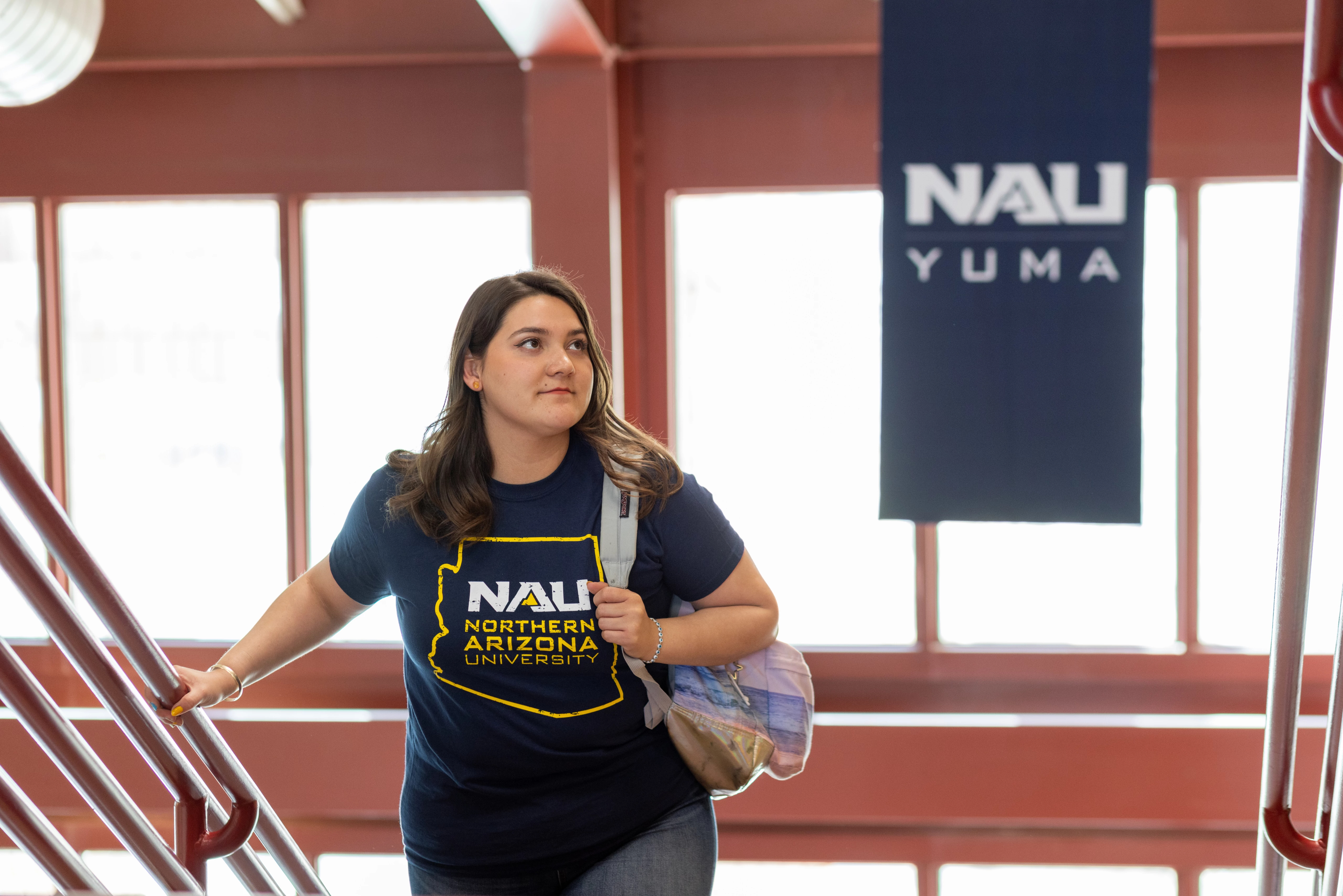 Student walking up a staircase at N A U&ndash;Yuma.