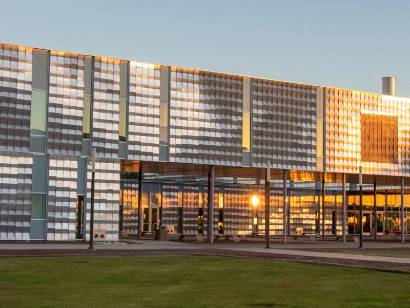 N A U&ndash;Yuma building with the sunshine reflecting from the it's panels.