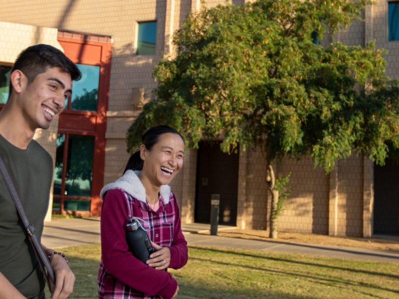 Students walking and laughing on the N A U&ndash;Yuma campus.