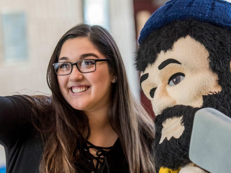 N A U&ndash;Yuma student taking aselfie with Louie the Lumberjack.