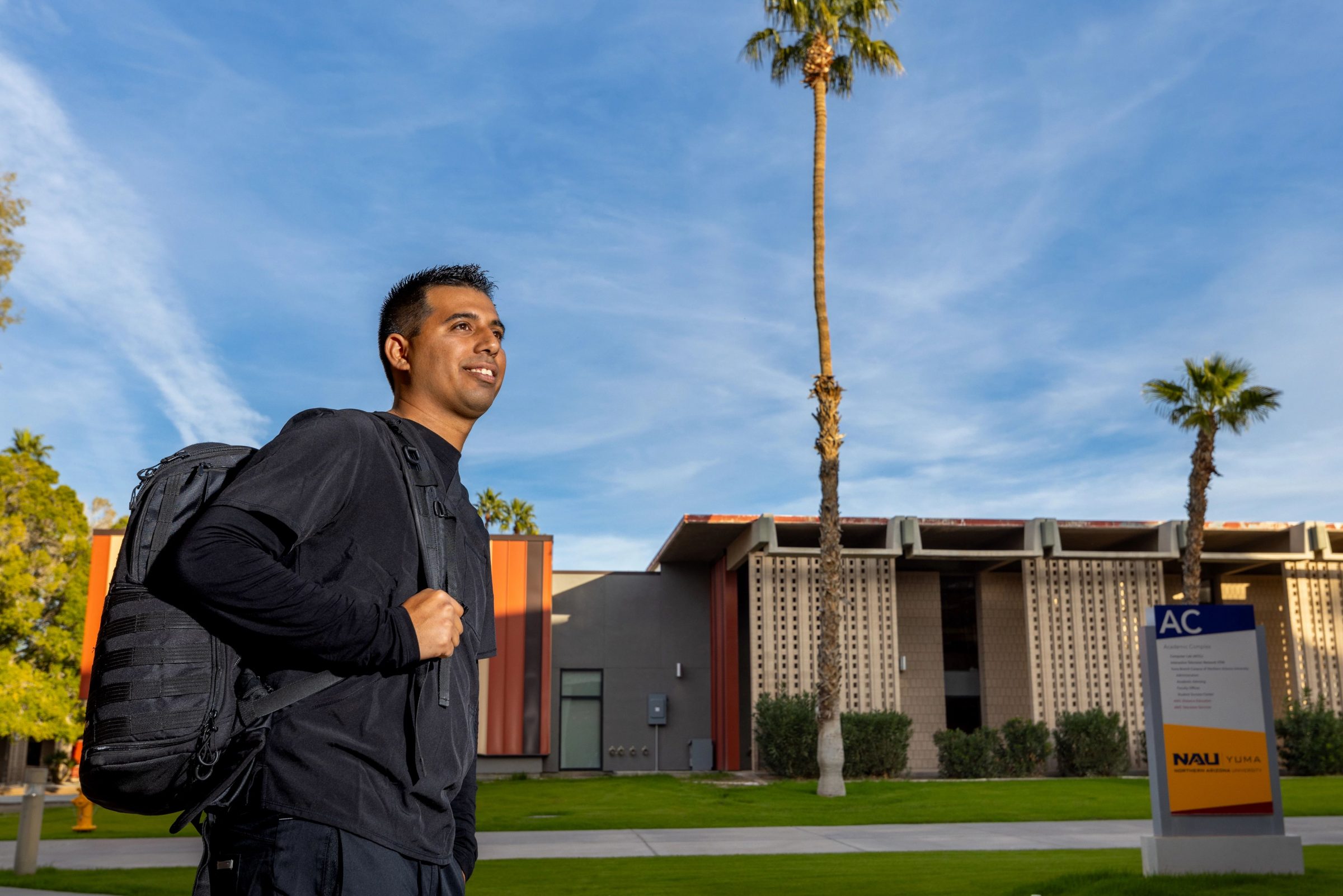 A student walks through the N A U Yuma campus.