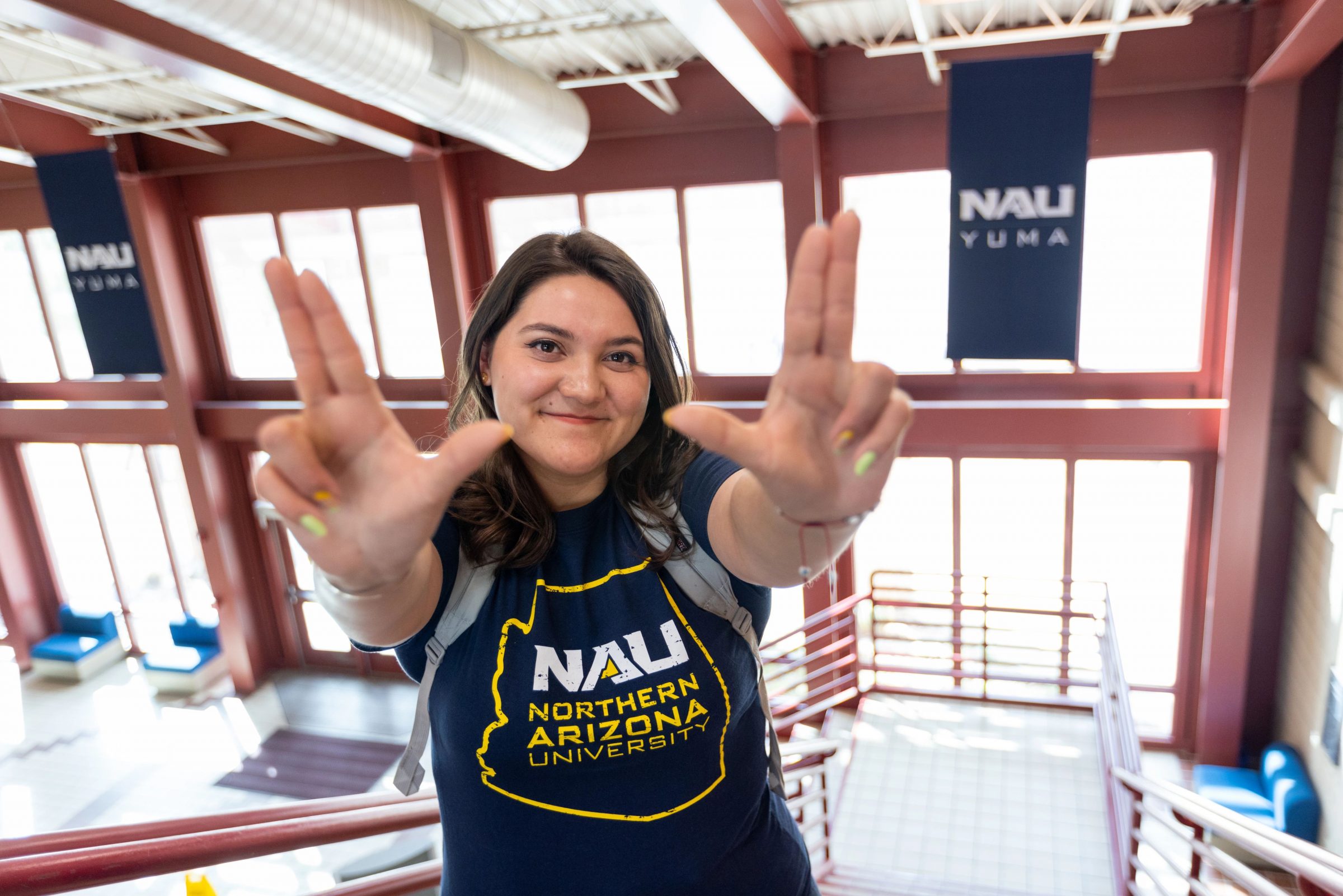 A Northern Arizona University student makes the "Lumberjacks" hand sign.
