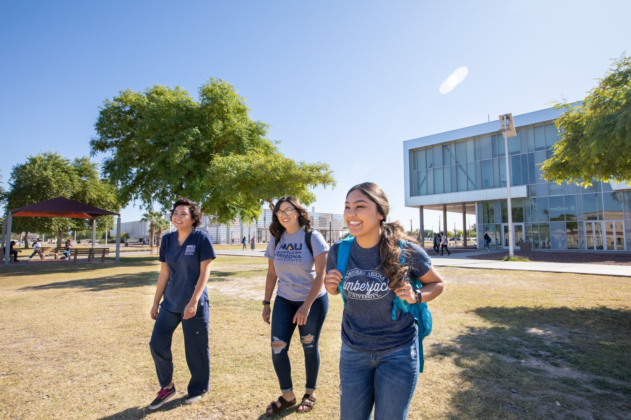 Students on campus walking on a field.