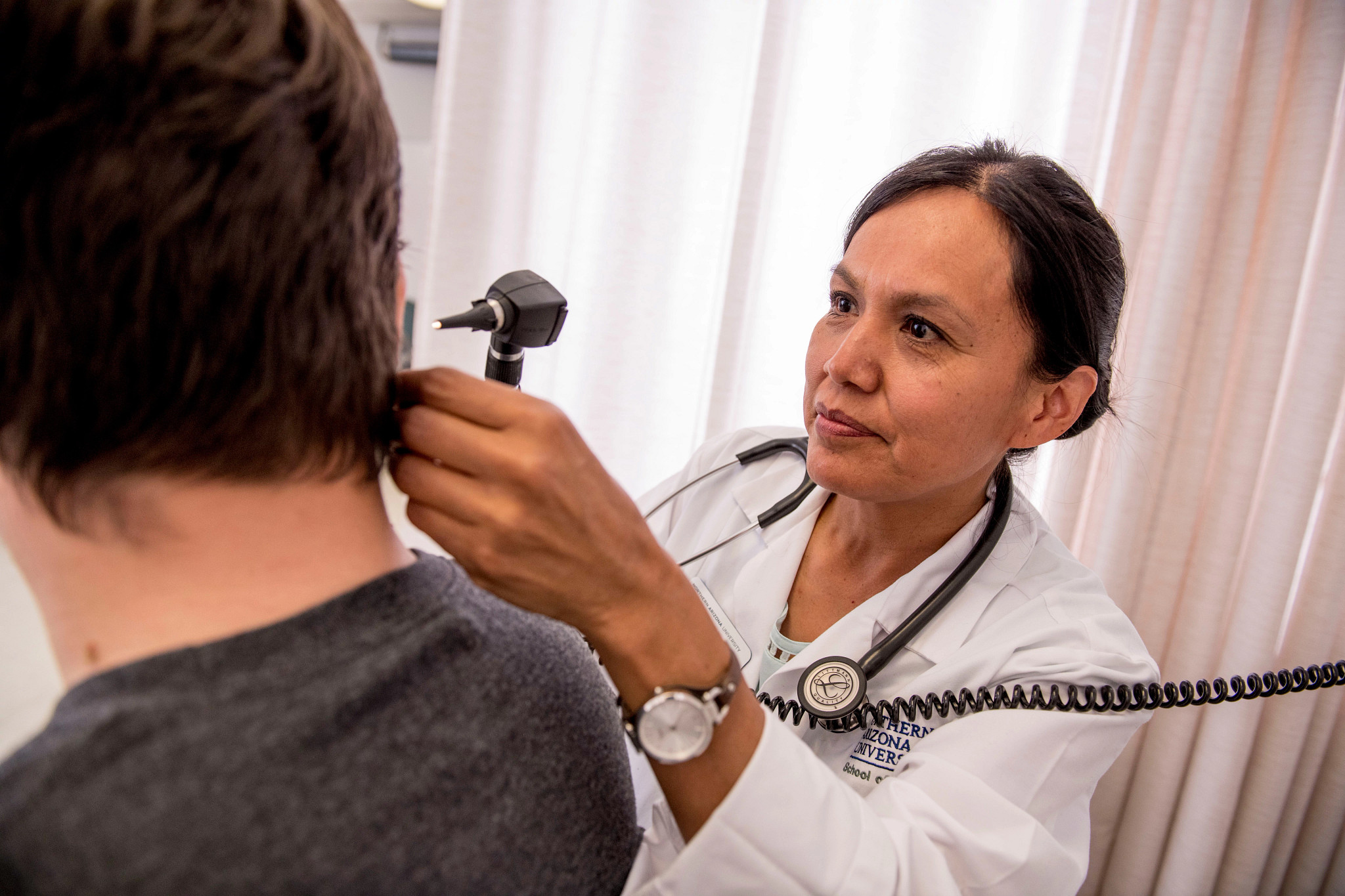Nurse examining patient.
