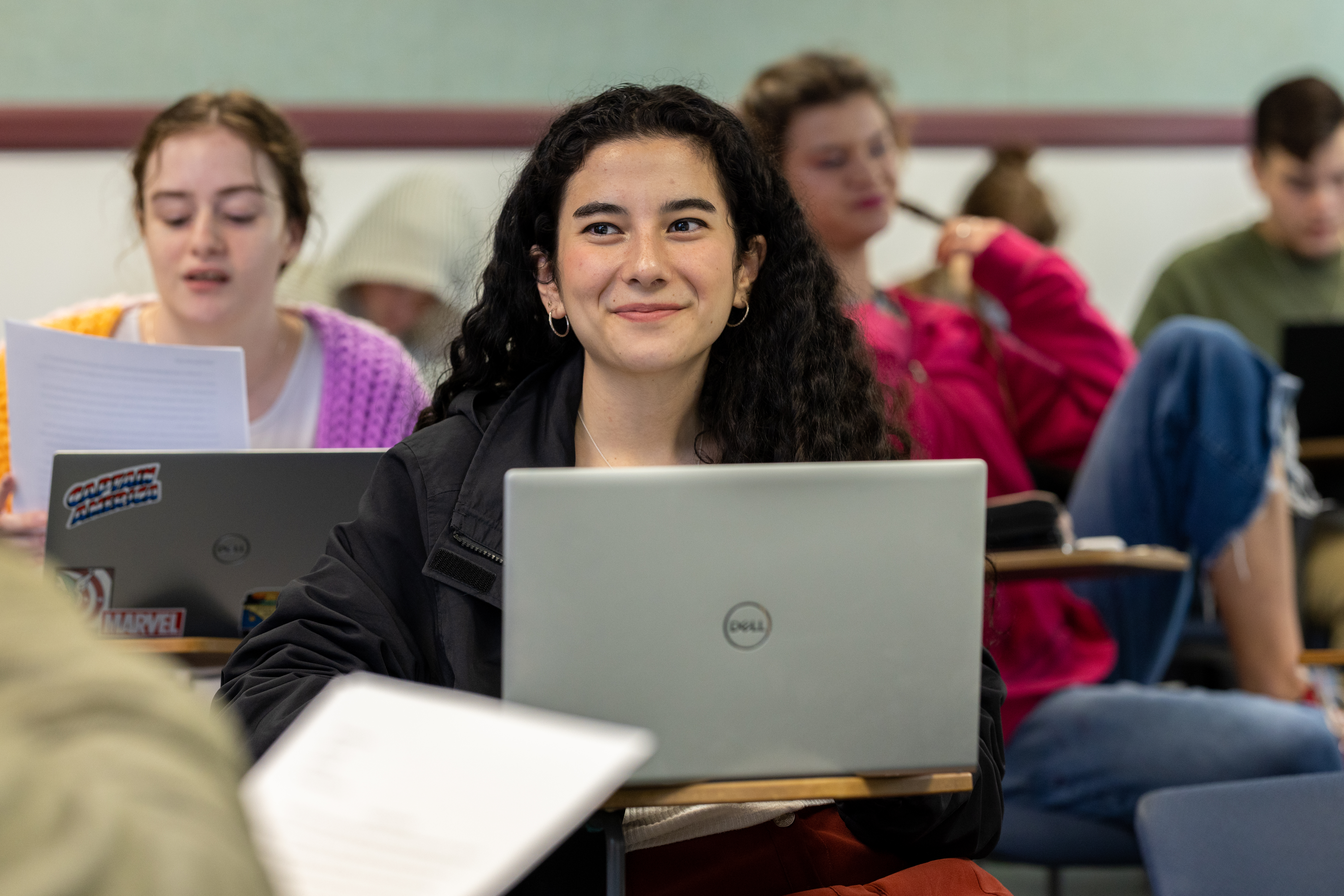 Student smiling in classroom.