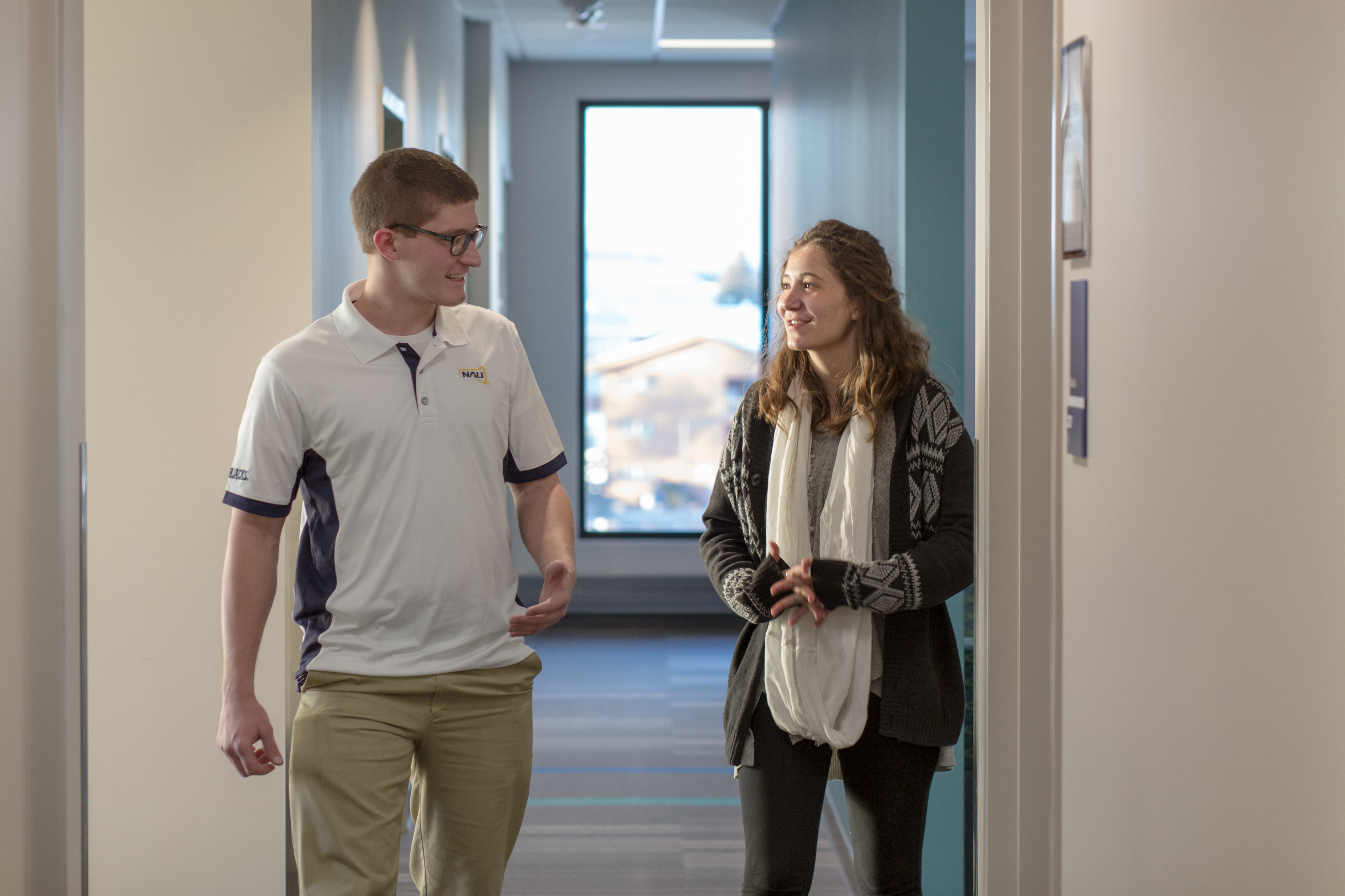 Student walking with faculty.