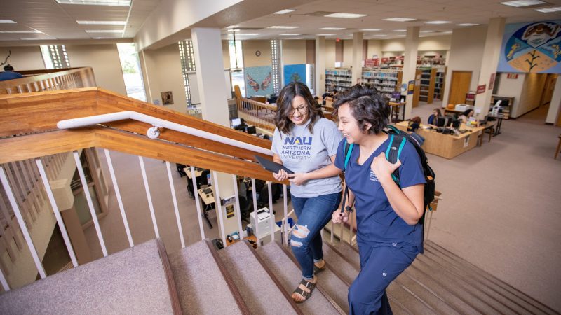 Students laughing and walking up stairs.