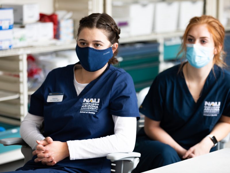 Nursing students listening to a classroom lecture.
