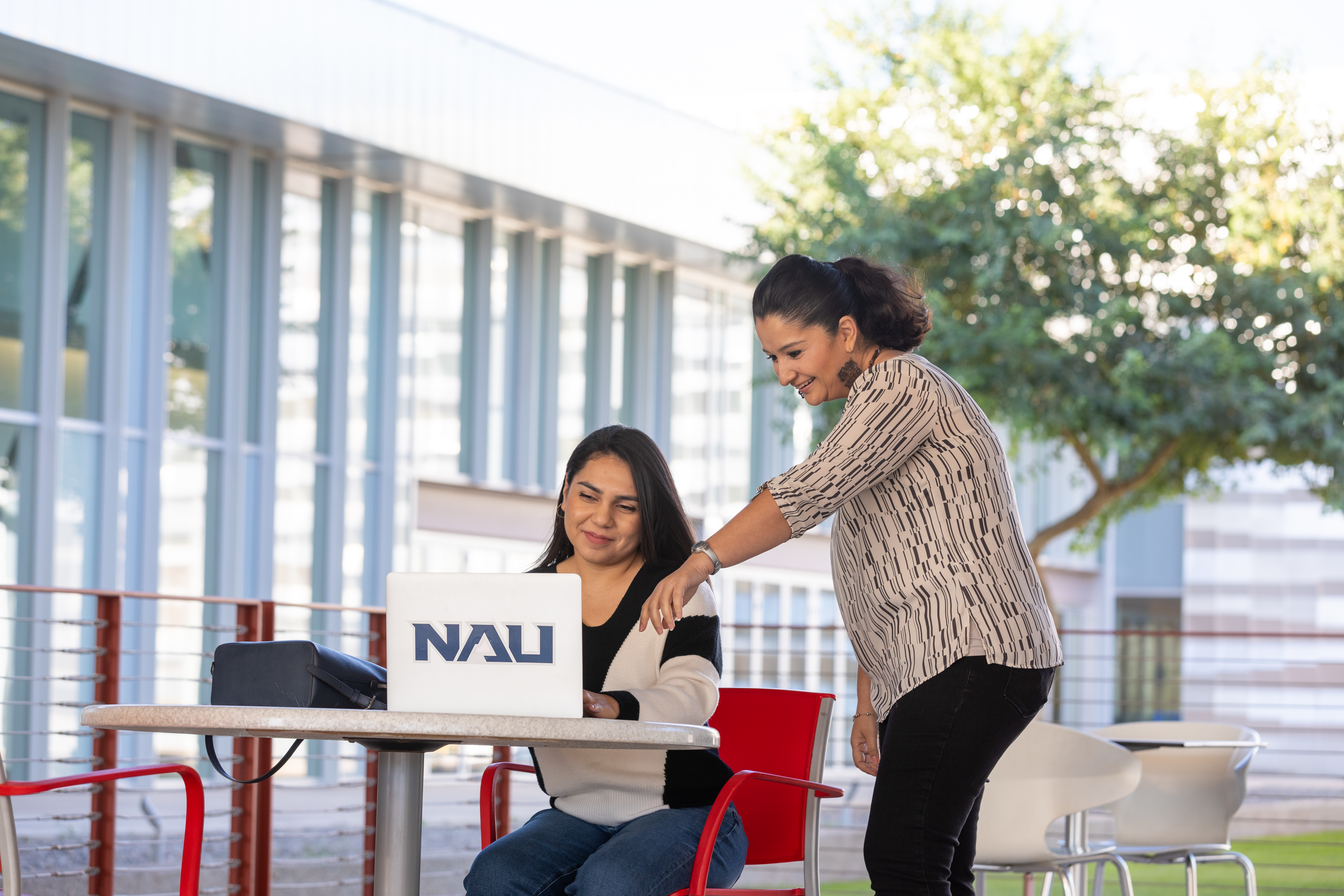 Student being helped by faculty outdoors.