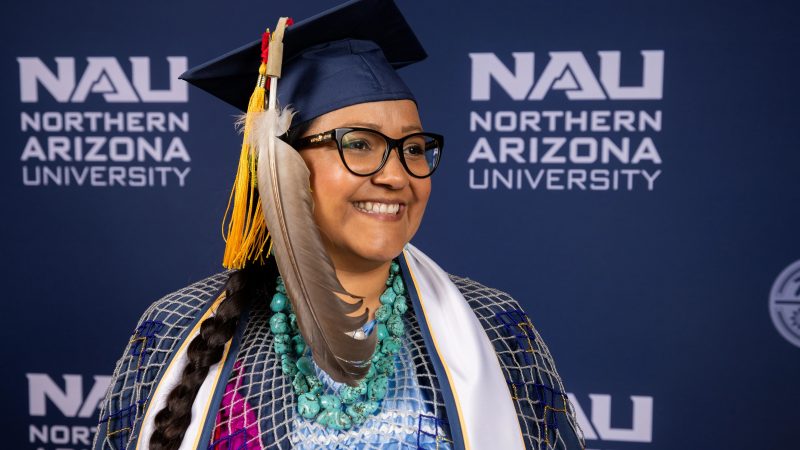 An indigenous student at N A U celebrates graduation.