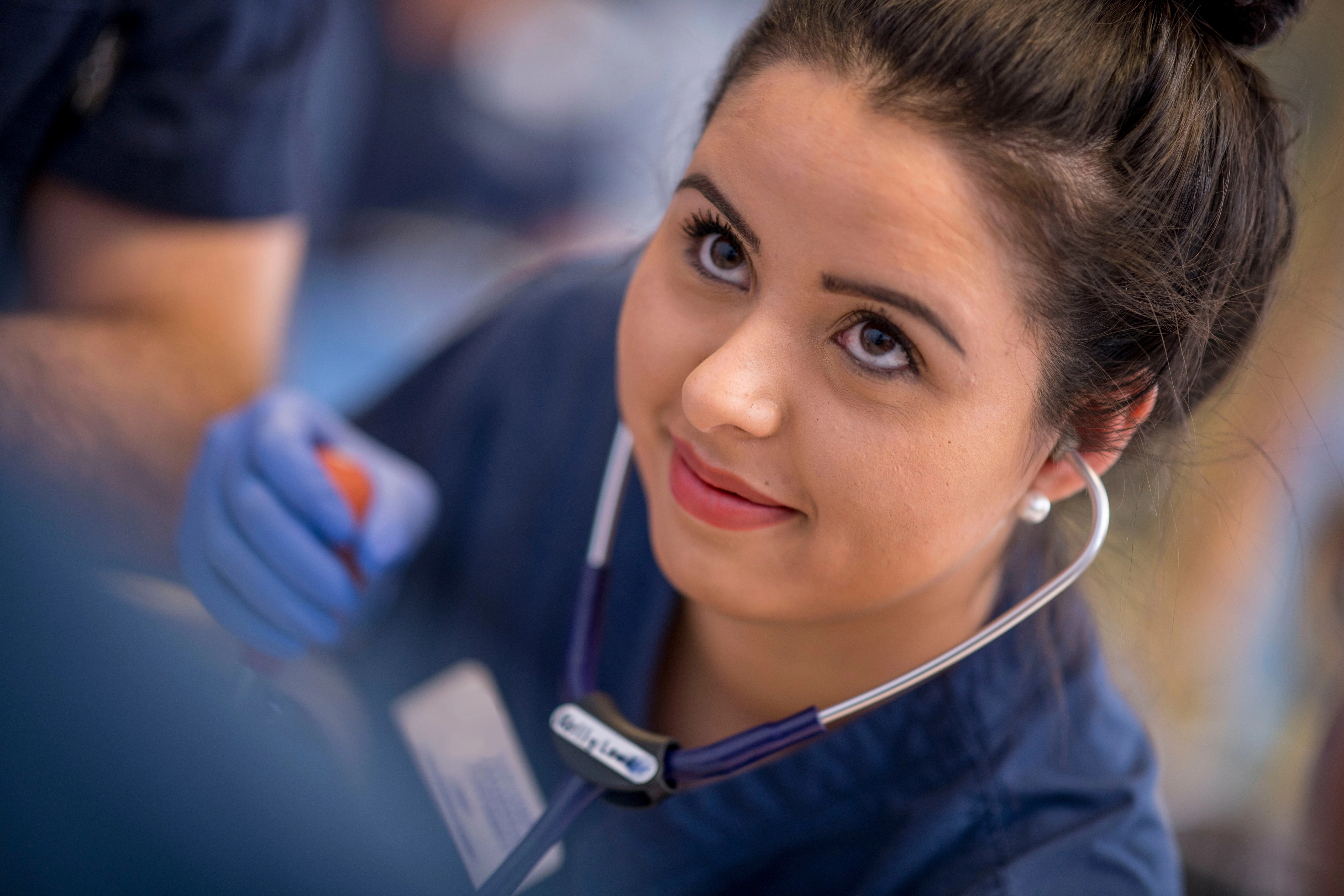 A nursing student at N A U interacts with a patient.