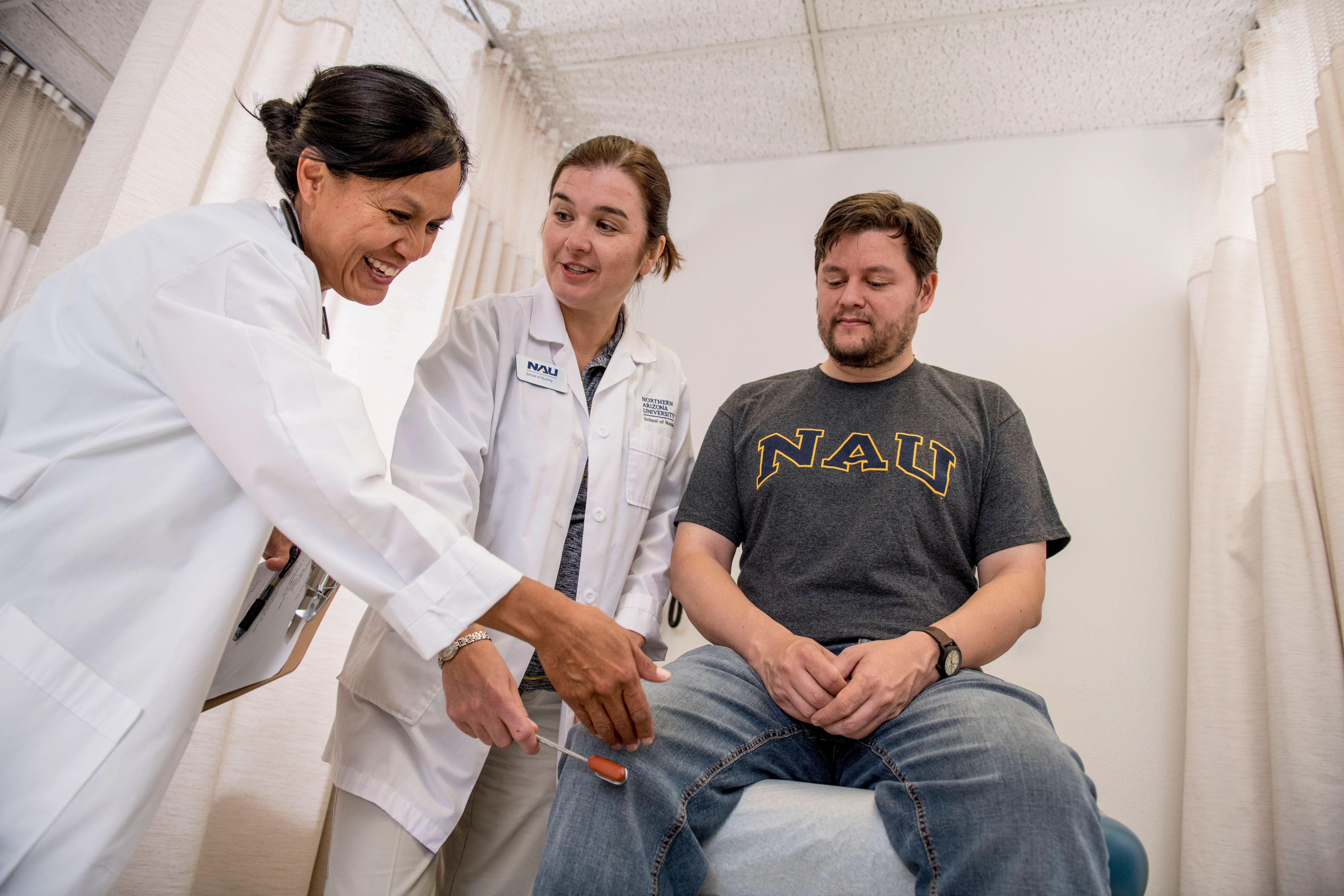 N A U Nursing graduate students trains interacting with patients with instructor guidance.