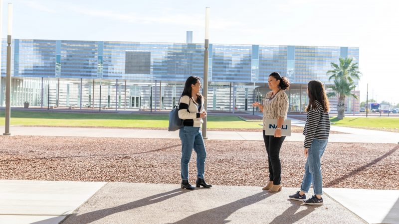 N A U&ndash;Yuma students chat with an advisor on campus.