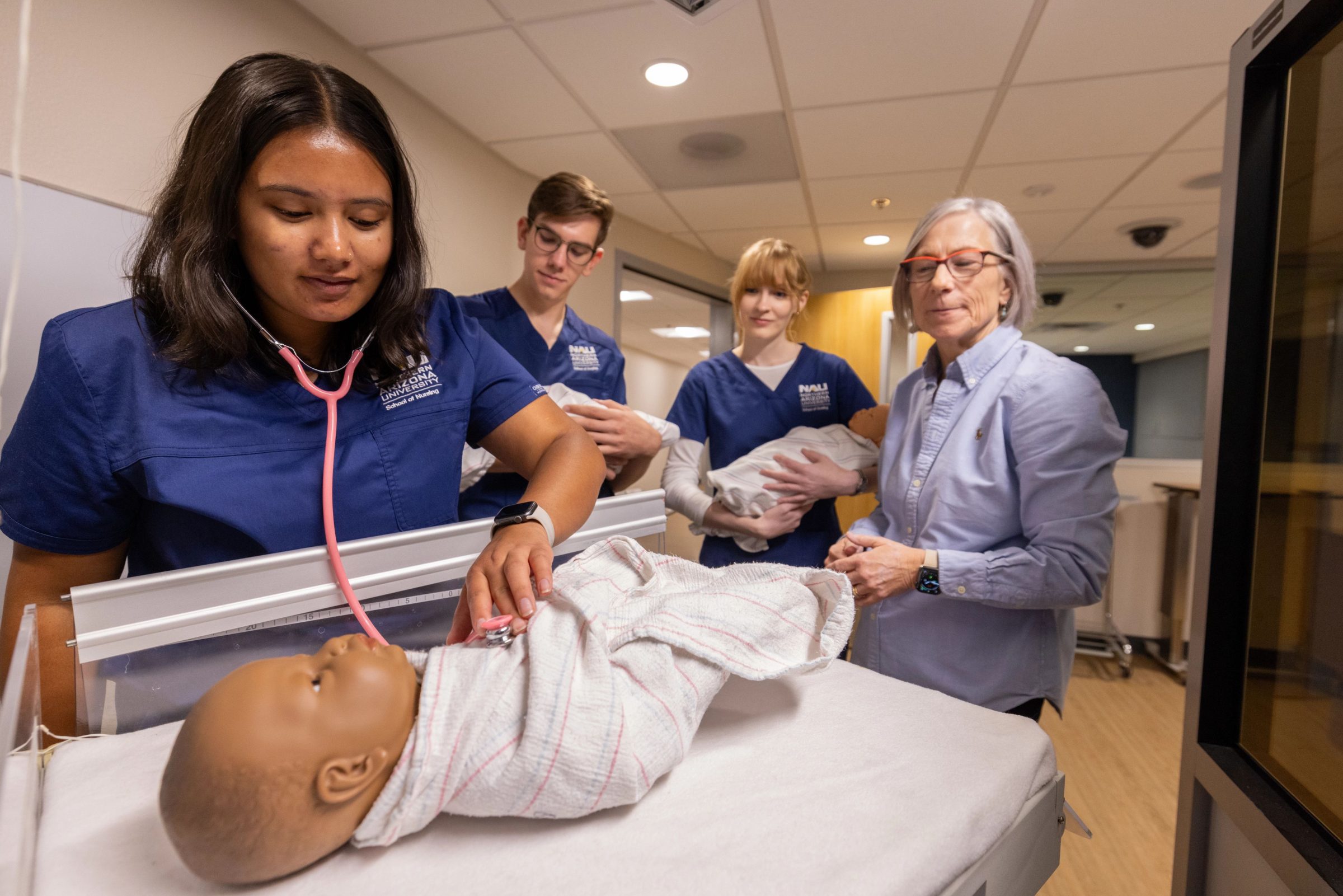 A nursing student uses a stethoscope during their studies