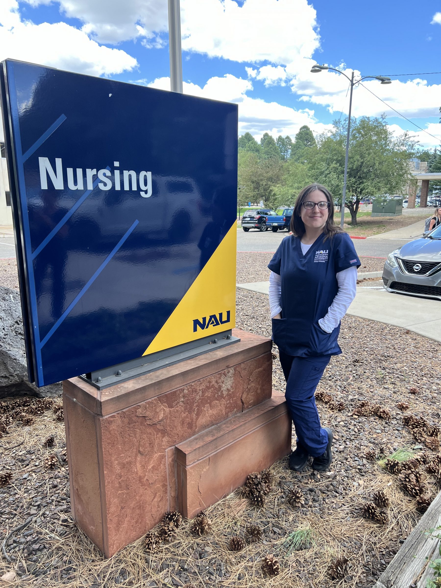 Nursing student posing with the N A U nursing sign.