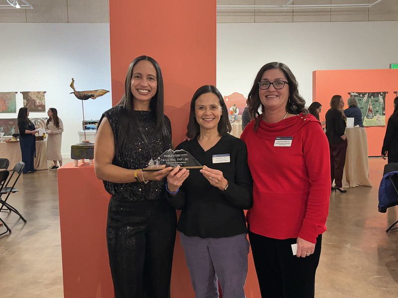 Three women pose for a photograph at the College of Nursing launch event.