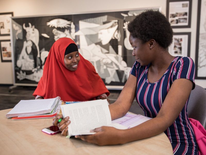 Two students sitting at a table and studying together.