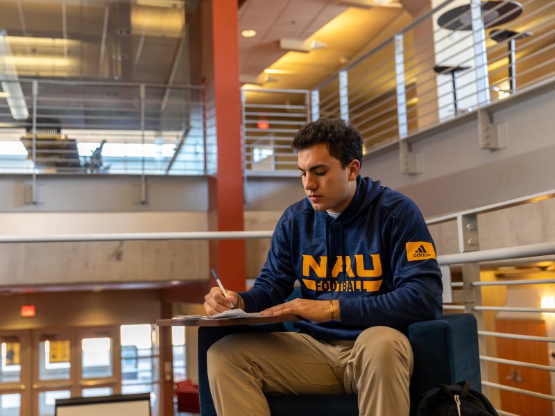 A student sitting at a desk and working.