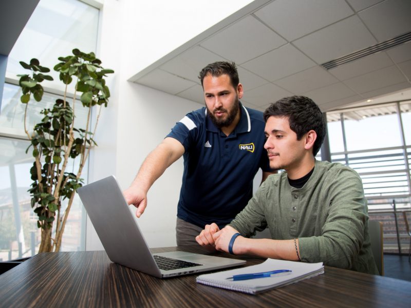 A photo of a student getting help from an advisor.