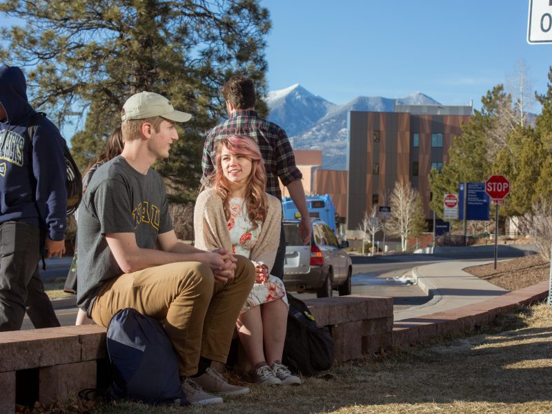 Students sitting outside and talking.