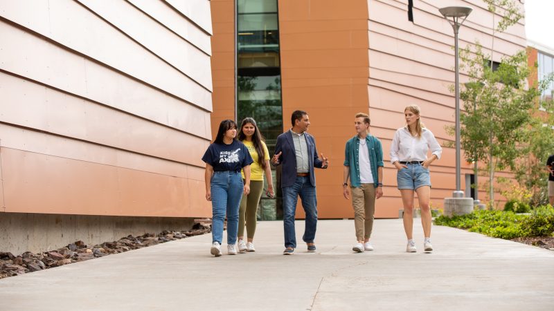 Dr. Jose Luis Cruz Rivera meets with students on campus.