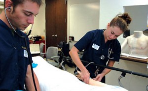 Two students caring for patient