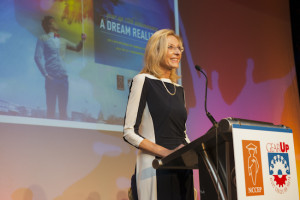 Teena Olszewski speaks at the podium at the event