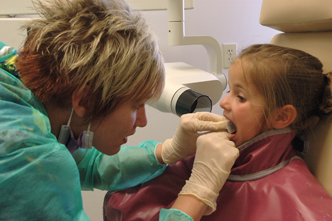 Dental hygiene student with a patient.