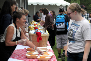 President Rita Cheng serves food at the President's Picnic