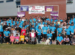 Crowd of volunteers and runners at the finish line