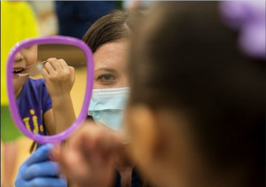 A dental student teaches flossing