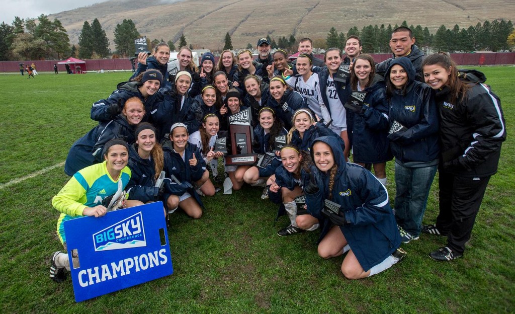 Women's soccer poses on the field