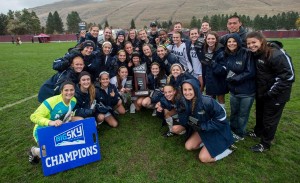 Women's soccer poses on the field