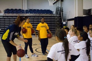 women's basketball members interact with youth
