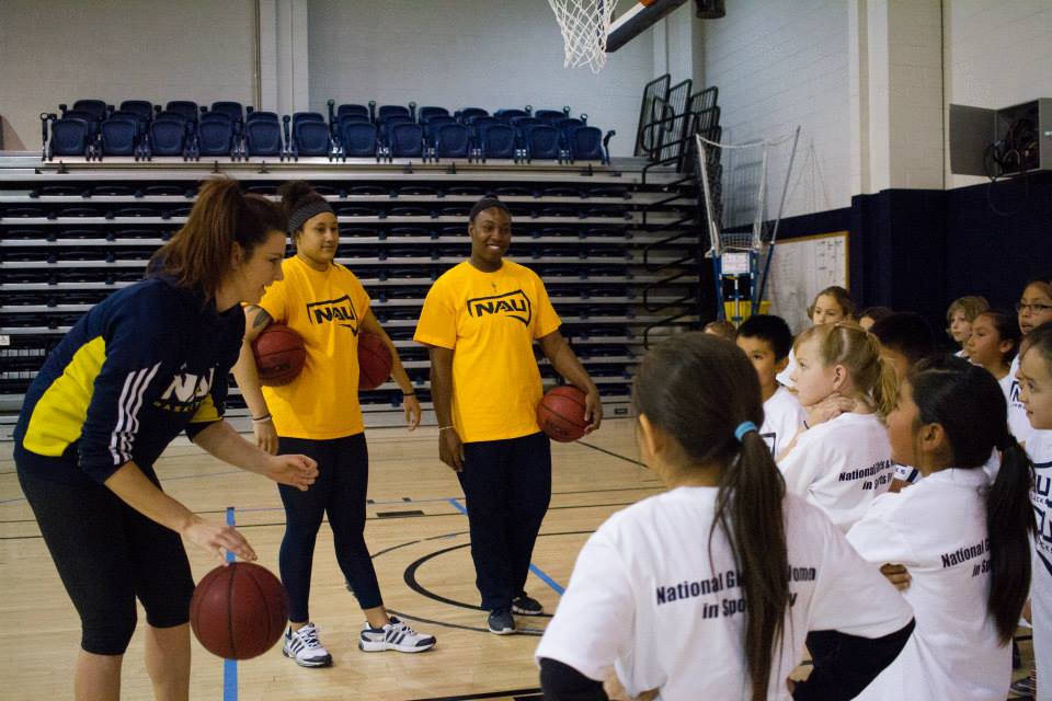 women's basketball members interact with youth